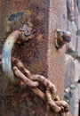Macro photo with a decorative background of rust on the metal surface of the chain and fence post