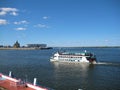 Macro photo with decorative background of transport riverboat during the summer navigation and the embankment of the European city