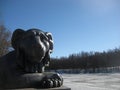 Macro photo with a decorative landscape background with an architectural structure of an iron sculpture of a lion on the river Royalty Free Stock Photo