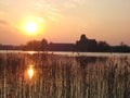 Macro photo with a decorative landscape background of the evening sky with a sunny sunset with the perspective of the ancient