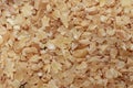 Macro photo of finely ground brown wheat groats for Russian porridge made from durum wheat. Top view, close-up. A source