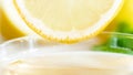 Macro image of fresh lemon slice above cup with tea Royalty Free Stock Photo