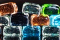 Macro photo of glass cubes of different colors on a black background with reflections Royalty Free Stock Photo