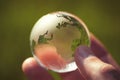 Macro photo of glass globe in human hand Royalty Free Stock Photo