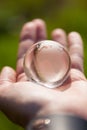 Macro photo of glass globe in human hand Royalty Free Stock Photo