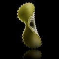 Macro photo of green farfalle pasta isolated on black with clipping path