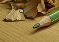 Macro photo of a green pencil with pencil shavings in the background Royalty Free Stock Photo