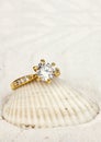 macro photo of jewelry ring with big diamond on white sand background Royalty Free Stock Photo