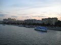 Macro photo with landscape background of a beautiful warm summer evening on the Moscow river with boats and walking trams Royalty Free Stock Photo