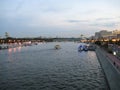 Macro photo with landscape background of a beautiful warm summer evening on the Moscow river with boats and walking trams Royalty Free Stock Photo