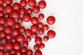 Macro photo of many red ball-shaped pills. Tibetan folk medicine from the herbal complex.