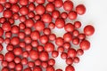 Macro photo of many red ball-shaped pills. Tibetan folk medicine from the herbal complex.