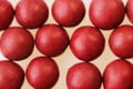 Macro photo of many red ball-shaped pills. Tibetan folk medicine from the herbal complex.