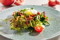 Macro Photo of mixed salad with poached egg, sliced sweet bell pepper, fresh lettuce leaves and cherry tomatoes. Restaurant starte Royalty Free Stock Photo