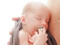 Macro photo of a newborn, Small ear close-up. Baby sleeping with a pacifier in his mouth on his fatherÃ¢â¬â¢s chest. Royalty Free Stock Photo