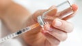 Macro image of nurse filling small syringe with drugs from vial Royalty Free Stock Photo