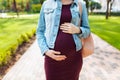Macro photo, pregnant woman hugs belly