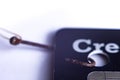 Macro photo of rusty fishing hook attached to credit card. concept of phishing attempt by a hacker