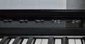 Macro photo of a satin black and white portable digital piano