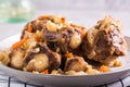 Macro photo of sliced stewed oxtail in vegetables on a plate