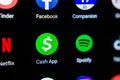 Macro photo of smartphone screen with a range of apps and a main focus on Cash App. Editorial Illustrative image