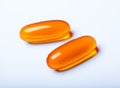 Macro photo of two orange pills isolated on white background Royalty Free Stock Photo