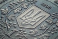 Macro photo of a Ukrainian coin. Ukrainian coat of arms trident on a coin, close-up