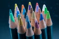 Macro photo of various colored pencils on a mottled blue background