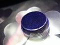 Macro photo violet blue eye shadow pigment glitter gloss cosmetic make up Royalty Free Stock Photo