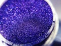 Macro photo violet blue eye shadow pigment glitter gloss cosmetic make up Royalty Free Stock Photo