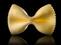 Macro photo of yellow farfalle pasta isolated on black with clipping path