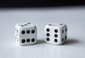 Macro photograhpy to an Old white dices with double six pair over a white table