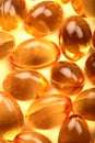 Cod-liver oil macro image of health capsules. Royalty Free Stock Photo