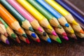 Macro photograph of colored school pencils, under rustic wood table