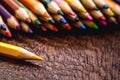 Macro photograph of colored school pencils, under rustic wood table, with copyspace for text Royalty Free Stock Photo