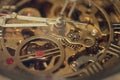 Macro photograph of the internal gears of the machine of a bronze and steel wristwatch. Selective focus