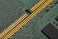 Macro close up of memory modules and micro surface mounted components on green printed circuit board with gold connector edge Royalty Free Stock Photo