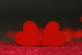 Macro photograph of red hearts on a dark background with blurred lights. Royalty Free Stock Photo