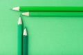 Macro photograph of several pencils of green color on a paper ba Royalty Free Stock Photo