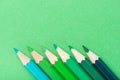 Macro photograph of several pencils of green color on a paper background Royalty Free Stock Photo