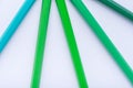 Macro photograph of several pencils of green color on a white ba Royalty Free Stock Photo