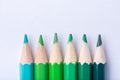 Macro photograph of several pencils of green color on a white ba Royalty Free Stock Photo