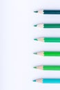 Macro photograph of several pencils of green color on a white background Royalty Free Stock Photo