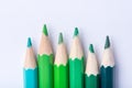 Macro photograph of several pencils of green color on a white background Royalty Free Stock Photo