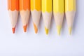 Macro photograph of several pencils of yellow and orange color o Royalty Free Stock Photo