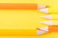 Macro photograph of several pencils of yellow and orange color o Royalty Free Stock Photo