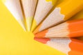 Macro photograph of several pencils of yellow and orange color o Royalty Free Stock Photo