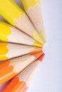 Macro photograph of several pencils of yellow and orange color o Royalty Free Stock Photo