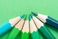 Macro photograph of several pencils of green color on a paper ba Royalty Free Stock Photo