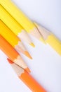 Macro photograph of several pencils of yellow and orange color o Royalty Free Stock Photo